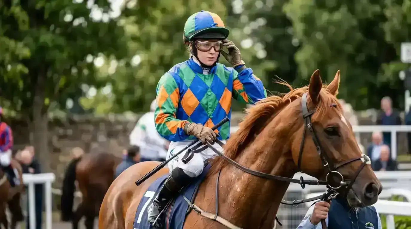 Jockey riding in a UK flat race with statistics overlay